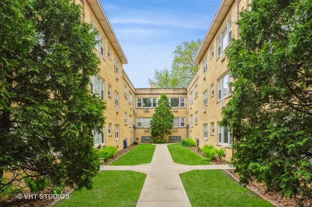 view of property's community with a lawn
