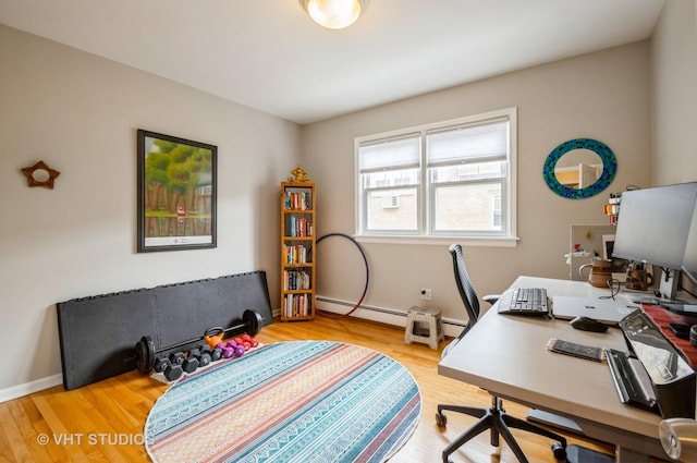 office featuring wood finished floors and baseboard heating