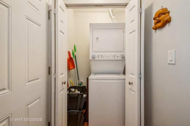 clothes washing area featuring stacked washer / drying machine