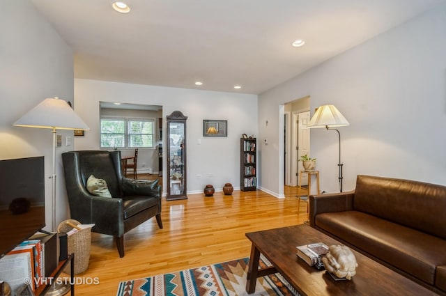 living area with light wood-type flooring, recessed lighting, baseboards, and baseboard heating