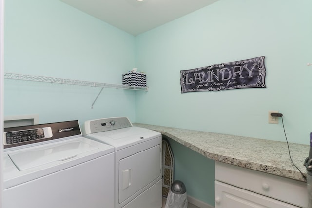 clothes washing area featuring laundry area and washer and clothes dryer