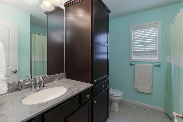 bathroom featuring toilet, tile patterned floors, visible vents, baseboards, and vanity