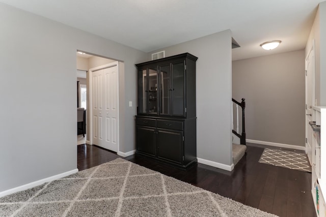 unfurnished bedroom with visible vents, wood finished floors, and baseboards