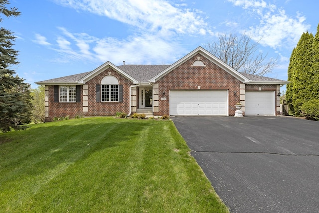 11920 Hunterston Dr, Caledonia, IL 61011 - ranch-style home featuring brick siding, aphalt driveway, a garage, a front yard, and roof with shingles