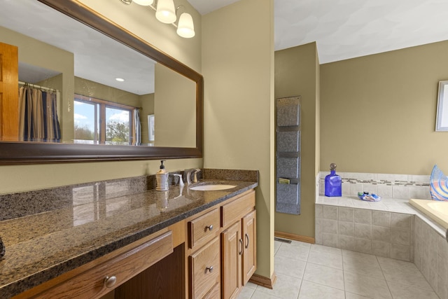 11920 Hunterston Dr, Caledonia, IL 61011 - bathroom with vanity, a relaxing tiled tub, baseboards, and tile patterned floors