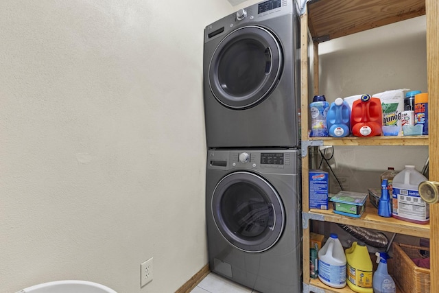 11920 Hunterston Dr, Caledonia, IL 61011 - clothes washing area featuring baseboards, tile patterned flooring, laundry area, and stacked washer and clothes dryer