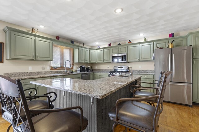 11920 Hunterston Dr, Caledonia, IL 61011 - kitchen with a sink, light wood-style flooring, green cabinets, and appliances with stainless steel finishes