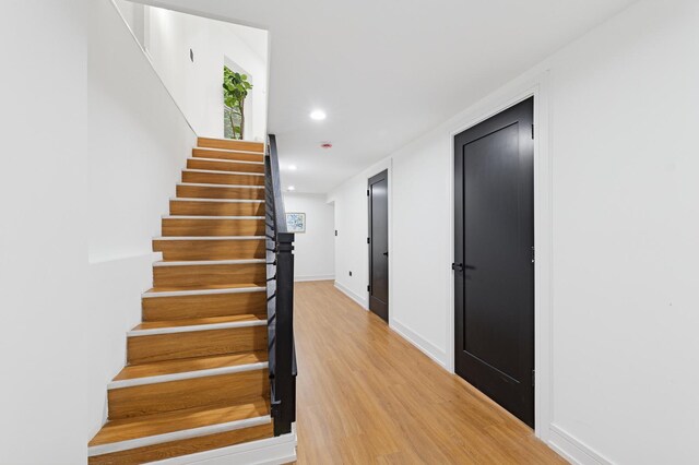 6430 S Eberhart Ave, Chicago, IL 60637 - hall featuring light wood-style flooring, recessed lighting, baseboards, and stairway