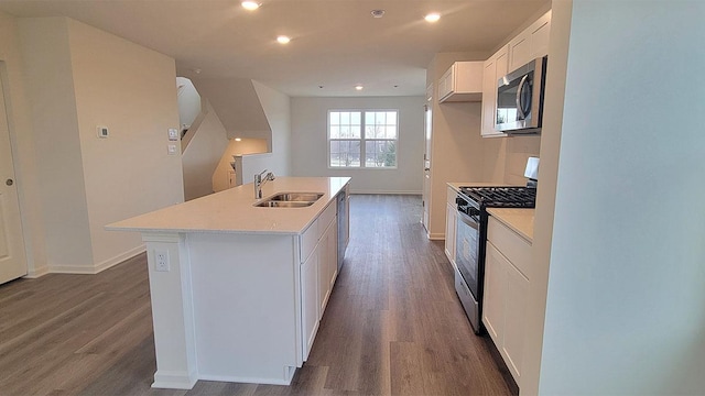 6600 Linden Trl Unit F, Wonder Lake, IL 60097 - kitchen featuring a kitchen island with sink, dark wood finished floors, stainless steel appliances, and a sink