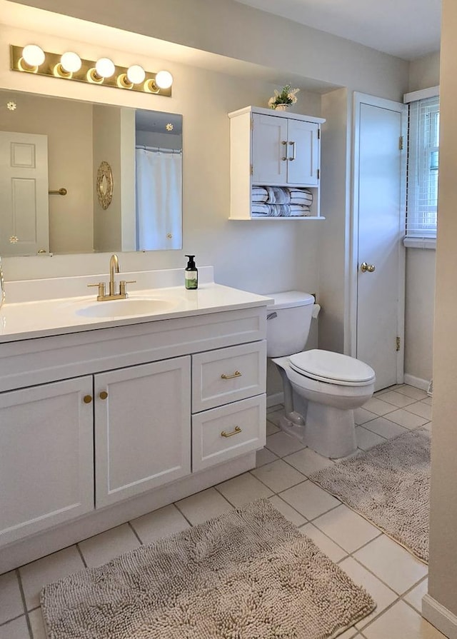 bathroom featuring tile patterned floors, toilet, and vanity
