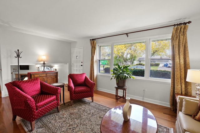 living area with wood finished floors and baseboards