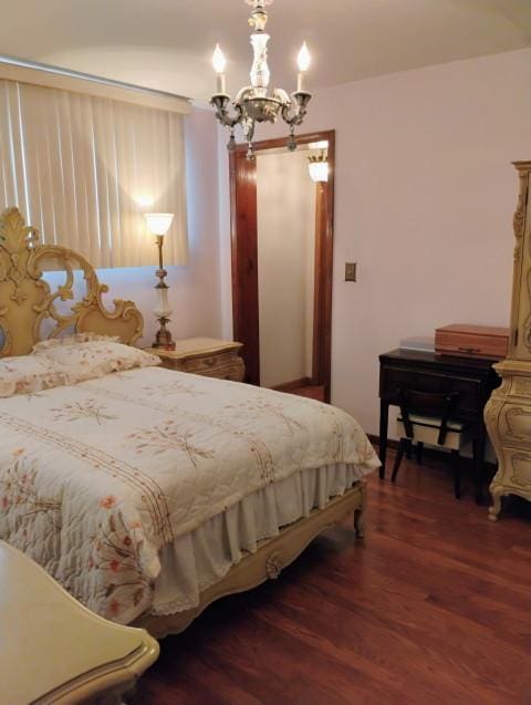 8856 Plainfield Rd, Brookfield, IL 60513 - bedroom with an inviting chandelier and wood finished floors