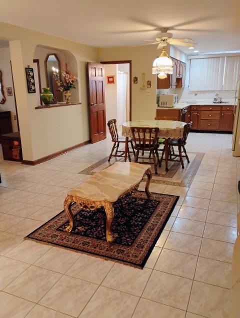 8856 Plainfield Rd, Brookfield, IL 60513 - dining room with baseboards, light tile patterned flooring, and ceiling fan