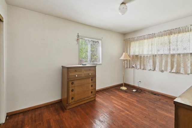 bedroom featuring baseboards, visible vents, and dark wood-style floors