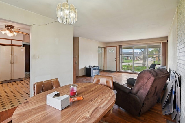 dining room featuring ceiling fan with notable chandelier