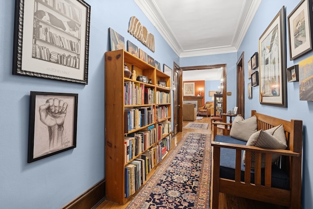 corridor featuring ornamental molding and wood finished floors