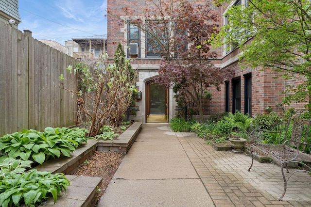 doorway to property with fence and brick siding