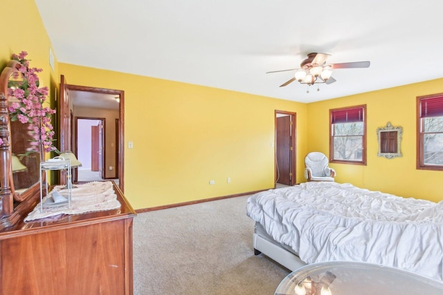 carpeted bedroom with baseboards and a ceiling fan
