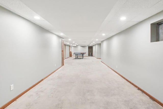 finished basement with baseboards and recessed lighting
