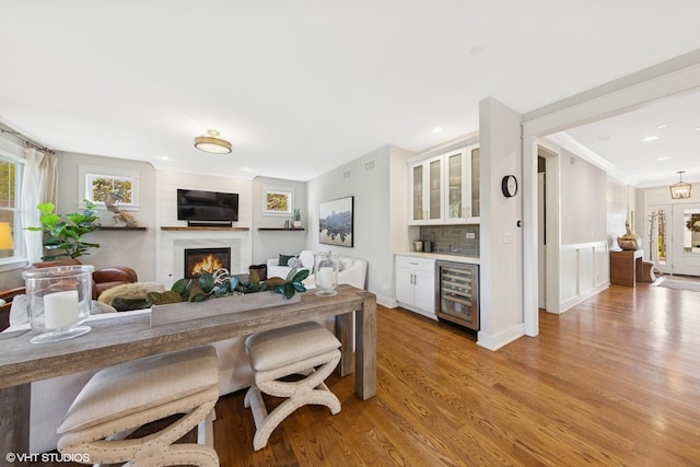 443 N Spring Ave, La Grange Park, IL 60526 - dining space with wine cooler, bar, light wood-style flooring, a lit fireplace, and recessed lighting