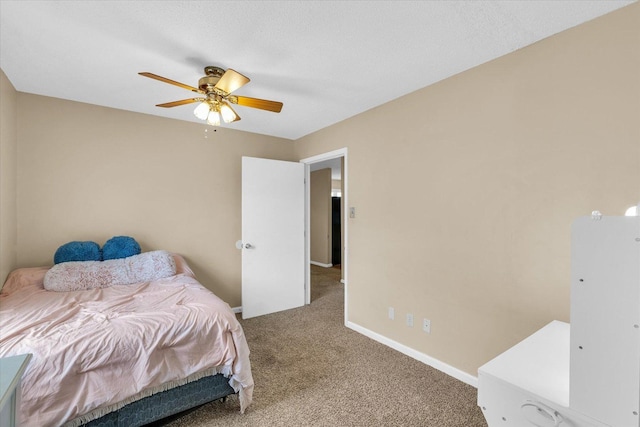 carpeted bedroom featuring baseboards and a ceiling fan