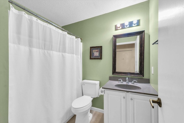 bathroom with a textured ceiling, toilet, baseboards, vanity, and wood finished floors