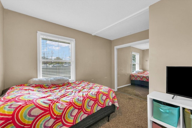 carpeted bedroom with baseboards