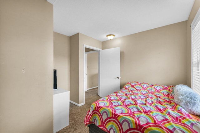 carpeted bedroom with multiple windows and baseboards