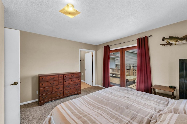 bedroom with carpet flooring, a textured ceiling, baseboards, and access to exterior