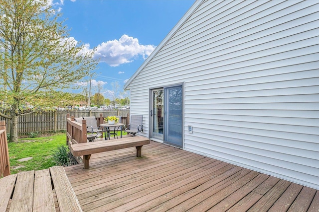 wooden deck featuring outdoor dining space and a fenced backyard