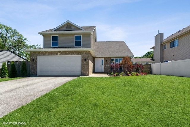 traditional-style house featuring fence, brick siding, concrete driveway, a garage, and a front lawn