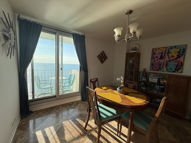 6033 N Sheridan Rd Unit 12B, Chicago, IL 60660 - dining space featuring a chandelier, baseboards, a water view, and stone finish floors