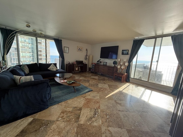 6033 N Sheridan Rd Unit 12B, Chicago, IL 60660 - living area with stone tile flooring and a wall of windows