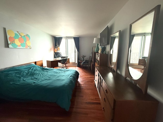bedroom with dark wood-style flooring