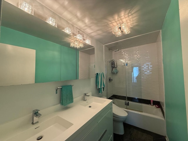 bathroom featuring toilet, washtub / shower combination, double vanity, and a sink