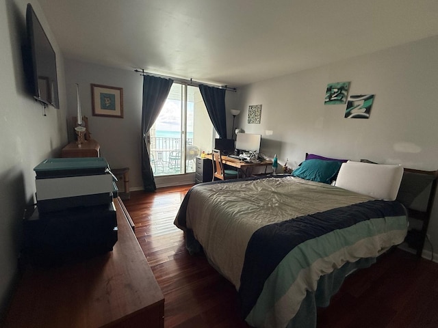 bedroom featuring wood finished floors and baseboards