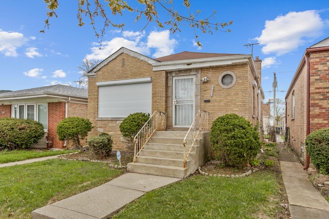10129 S Indiana Ave, Chicago, IL 60628 - view of front facade with a front lawn and brick siding
