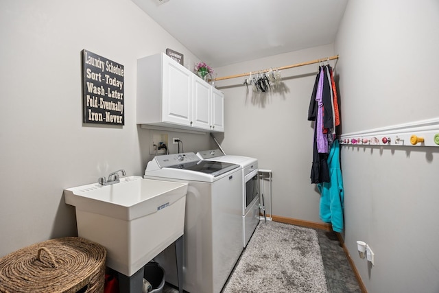 washroom featuring washer and clothes dryer and cabinet space
