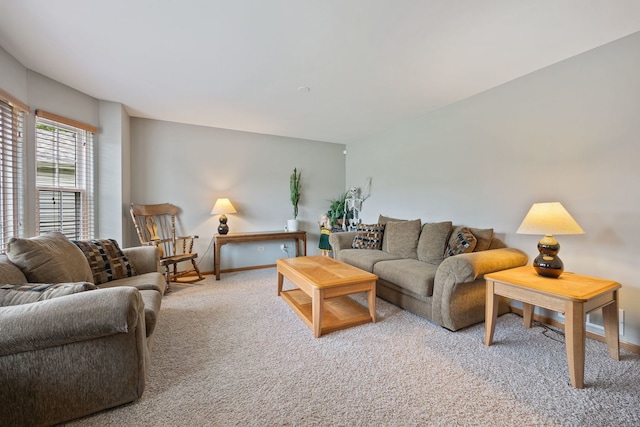 carpeted living area with baseboards