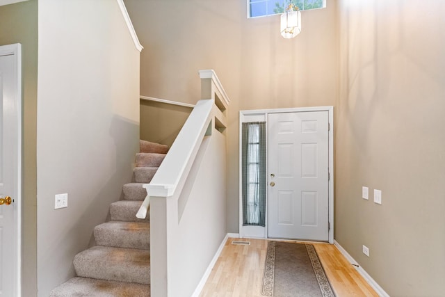 1277 Silk Oak Ln, Bartlett, IL 60103 - entryway featuring wood finished floors, a towering ceiling, stairs, and baseboards