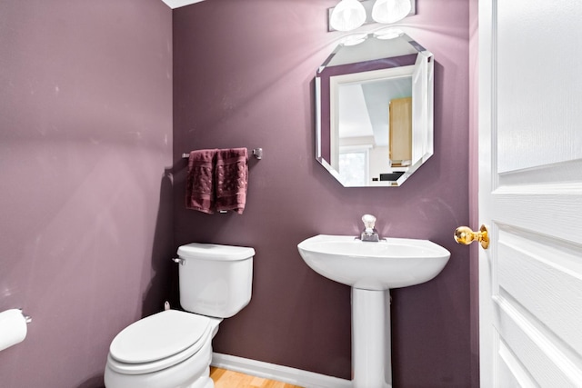 1277 Silk Oak Ln, Bartlett, IL 60103 - bathroom with toilet, baseboards, wood finished floors, and a sink