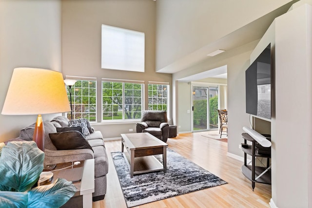 1277 Silk Oak Ln, Bartlett, IL 60103 - living room featuring light wood-style flooring, baseboards, and a high ceiling