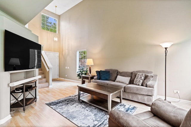 1277 Silk Oak Ln, Bartlett, IL 60103 - living room with high vaulted ceiling, light wood-style floors, baseboards, and stairway