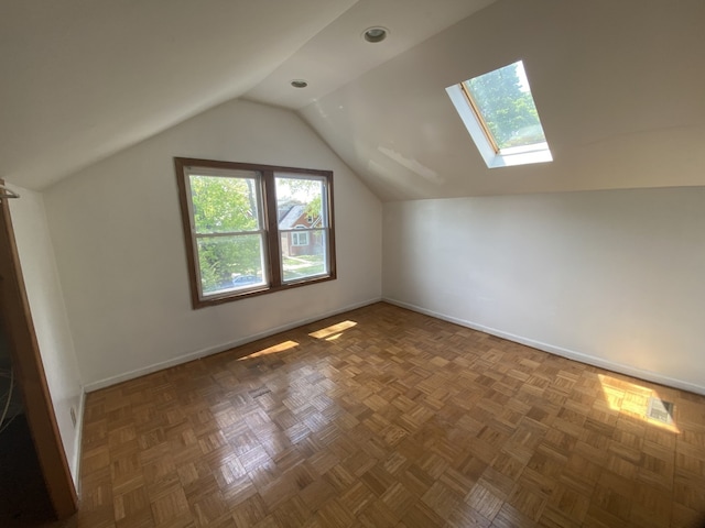 5014 W Strong St, Chicago, IL 60630 - additional living space with vaulted ceiling, baseboards, and a skylight