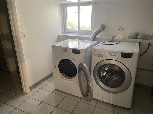 5014 W Strong St, Chicago, IL 60630 - laundry area with washing machine and clothes dryer and light tile patterned floors