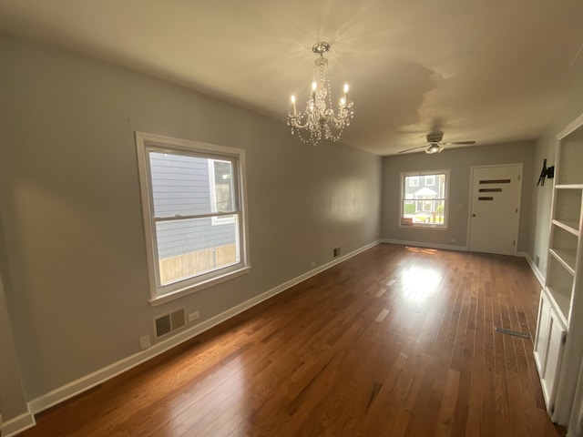 5014 W Strong St, Chicago, IL 60630 - spare room featuring a chandelier, dark wood finished floors, ceiling fan, and baseboards