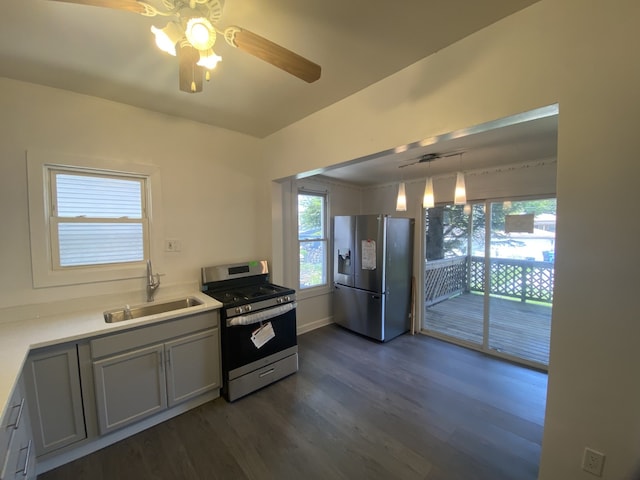 5014 W Strong St, Chicago, IL 60630 - kitchen featuring stainless steel appliances, a sink, a ceiling fan, dark wood-style floors, and light countertops