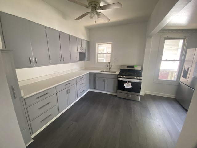 5014 W Strong St, Chicago, IL 60630 - kitchen featuring appliances with stainless steel finishes, gray cabinets, a sink, ceiling fan, and light countertops