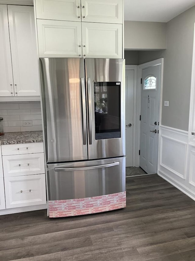 kitchen with smart refrigerator, white cabinetry, dark wood-style flooring, and light stone counters