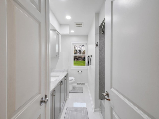 bathroom featuring toilet, visible vents, baseboards, tile patterned flooring, and vanity